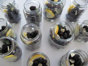 Half fill each jar with olives then add flavours